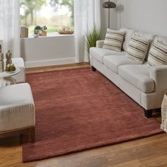 a living room filled with furniture and a red rug