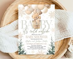 a baby shower is set up on top of a wooden bowl with white snowflakes