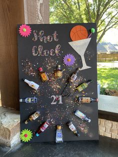 a chalk board with bottles and confetti on it