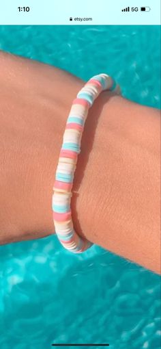 a woman's arm wearing a bracelet with multicolored stripes on it and the words, i love you