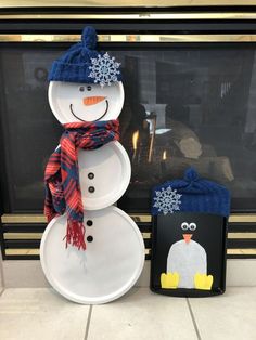 a snowman and penguin are sitting next to each other