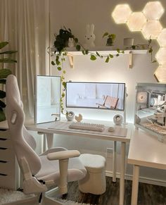 a white desk with a computer monitor and keyboard sitting on top of it next to a chair