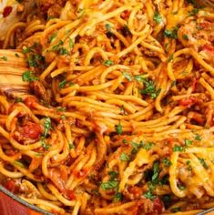 a skillet filled with spaghetti and meat