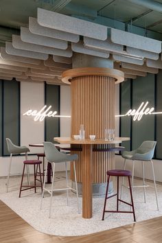 a coffee shop with stools and tables in the center, surrounded by wooden columns