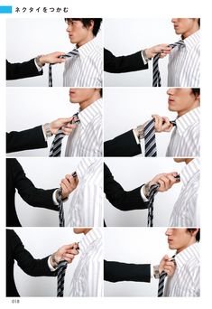 the man is tying his tie before he gets dressed in black and white striped shirt