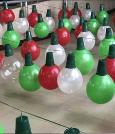 christmas lights are hanging from the ceiling in an indoor area with green and red bulbs