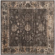 an antique rug with floral design on the middle and brown, beige and tan colors