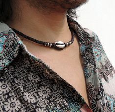 men's necklace with brown braided leather and metal shell in the center, it has a comfortable clasp to remove and put the leather is slightly engraved and vegetable tanned so the leather is free of chemicals metal is nickel free metal and silver plated It has a casual, surfer and very beachy style If you need a size different from the ones that appear in the options send us the measurement and we do it for you. Designed and hand crafted by Gongoria there are more models VISIT SHOP gongoria.etsy. Leather Necklaces, Surfer Jewelry, Mens Beaded Necklaces, Rustic Necklace, Beachy Jewelry, Shell Choker, Surfer Necklace, Beach Necklaces, Unique Gifts For Men