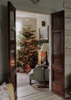 a living room with a christmas tree in the corner