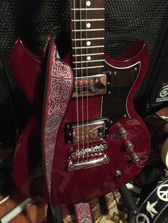 a red guitar with an intricate design on it