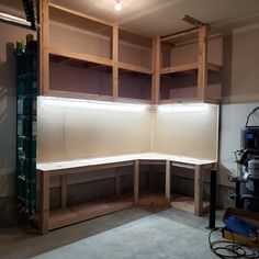 an unfinished room with shelves and lights in the corner, ready to be built into the wall