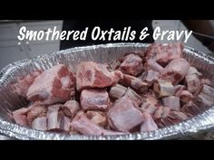 a metal pan filled with raw meat on top of a counter