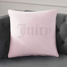 a pink pillow with the word juicy on it