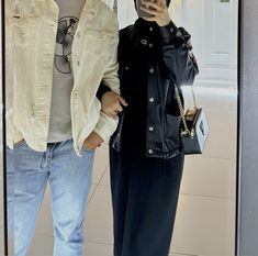 a man and woman taking a selfie in front of a mirror