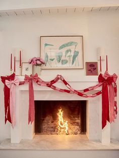 a fireplace decorated with red and white ribbon