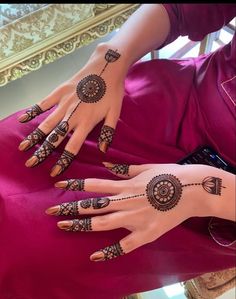 a woman with henna tattoos on her hands