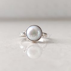 Stone : Pearl Metal : 925 Sterling Silver Stone Size : 10mm Shape : Round Band Size : 2mm Ships worldwide from India 925 stamped Handmade Item STYLE STATEMENT Be it ethnic or casual wear, this ring is sure to add style to your look. Match it with any attire and stay trending at all times. CUSTOMIZATION We welcome customization.Change in gemstone or design as per your need can be done. The stone size can also be changed as per your need. We are just a message away OUR QUALITY * All our products a Ring Pearl, Freshwater Pearl Ring, Minimalist Ring, Minimalist Rings, Silver Pearls, Style Statement, Pearl Ring, Ring Ring, Ring For Women