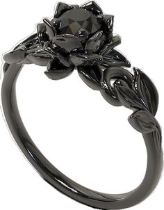 a black diamond flower ring with leaves on the sides and an oval center stone in the middle