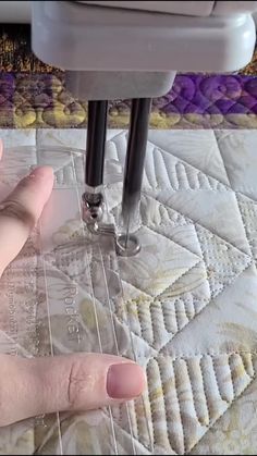 someone is using a machine to make quilts