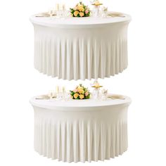 two tiered tables with flowers and candles on them