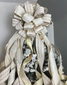 This beautiful bow is made of three different ribbons in gold.  Sparkling in gold glitter ribbons feature glittering Christmas trees.   This bow shines with the color of the season and will accent your tree beautifully.  Twelve streamers fall from 40 loops of ribbon. Bow is approximately 15 by 15 inches and features various sizes of flowing streamers.  Bow is shown on a 6 foot tree.  Made in North Carolina. Bow For Christmas Tree Topper, Ribbons For Christmas Tree, Christmas Tree Topper Gold, Bow For Christmas Tree, Topper For Christmas Tree, Gold Christmas Tree Topper, Gift Wrapping Tutorial, Tree Bows, Wrapping Tutorial