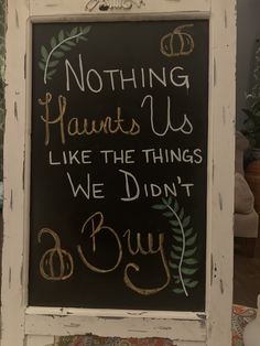 a chalk board with writing on it that says nothing laughs us like the things we didn't buy