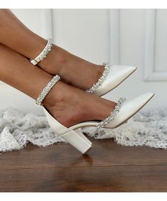 a woman's legs wearing white high heels