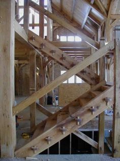 the inside of a wooden building with stairs and railings in place to climb up