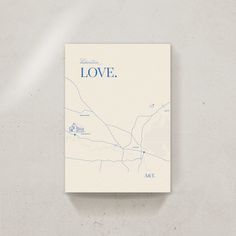 a white book with the word love on it and a blue map in the middle