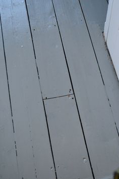 a white refrigerator sitting on top of a wooden floor