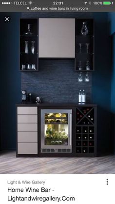 a wine cooler in the corner of a room with shelves and glasses on top of it