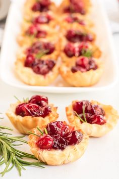 small cranberry tarts with rosemary sprigs on the side, ready to be eaten