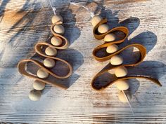 two wooden spoons are shaped like christmas trees