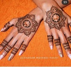 two hands with henna tattoos on them