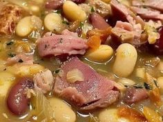 a bowl filled with meat, beans and vegetables