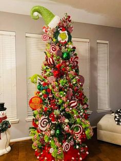 a christmas tree decorated with candy canes and elf hats