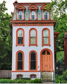 an orange and white house with trees in the background