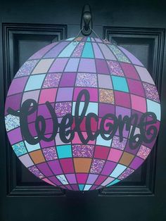 a colorful door with the word welcome painted on it's side and an air balloon in the middle