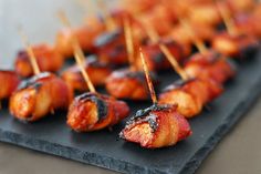 bacon wrapped in toothpicks on a slate platter for an appetizer