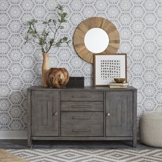 a grey dresser with two vases and a mirror on top