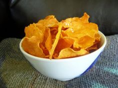 a white bowl filled with chips on top of a table