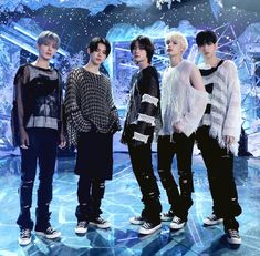 the group of young men are standing together in front of an ice - covered background