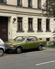 two cars are parked in front of a building