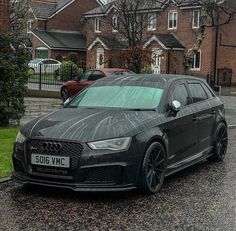 a black car is parked on the street