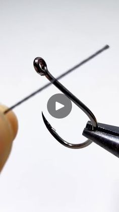 a fishing hook being hooked up with a needle