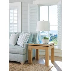 a living room filled with furniture and a window covered in white shuttered glass shades