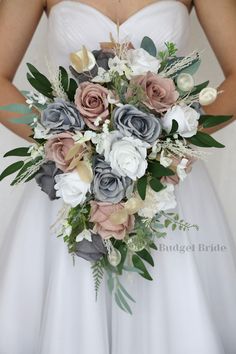 a bridal holding a bouquet of flowers and greenery