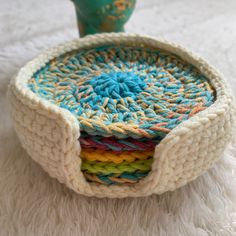 there is a crocheted basket with four different colors in it