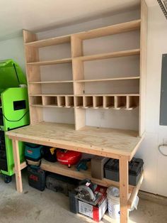 an unfinished workbench with shelves and tools