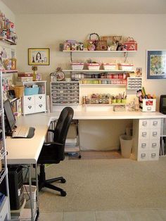 a home office with lots of storage space and shelves on the wall, along with two computer desks